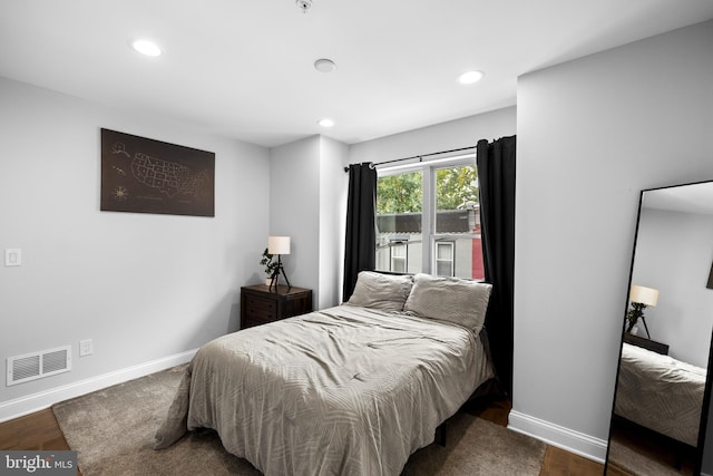 bedroom featuring dark hardwood / wood-style flooring