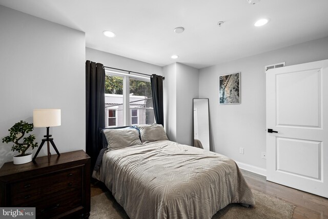 bedroom with dark wood-type flooring