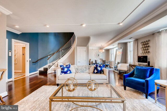 living room with ornamental molding and hardwood / wood-style floors