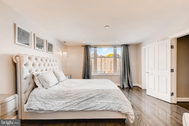 bedroom featuring baseboards and wood finished floors