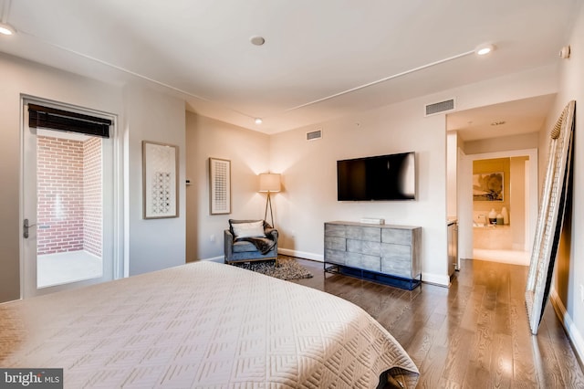 bedroom with access to exterior, visible vents, baseboards, and wood finished floors