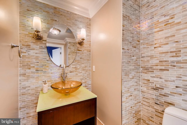 half bath featuring toilet, ornamental molding, and vanity