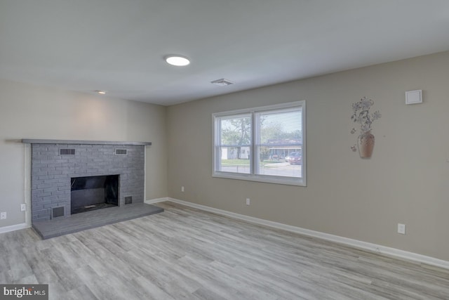 unfurnished living room with light hardwood / wood-style flooring and a fireplace