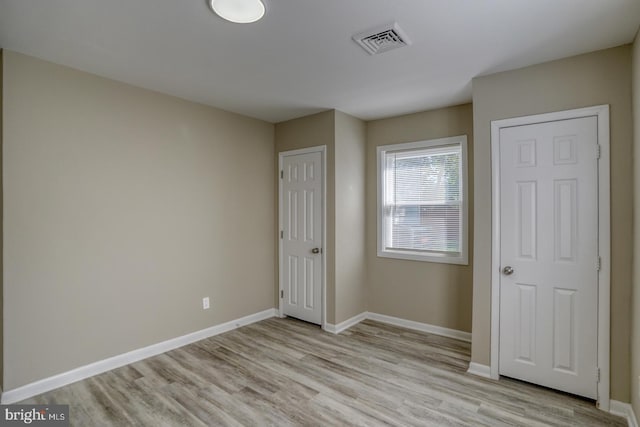 unfurnished bedroom featuring light wood-type flooring