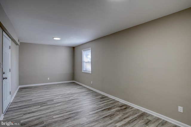 unfurnished bedroom with light wood-type flooring and a closet