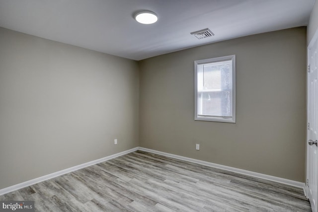 unfurnished room with light wood-type flooring