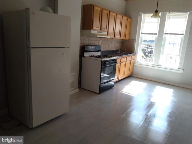 kitchen with decorative backsplash, sink, hanging light fixtures, and white appliances