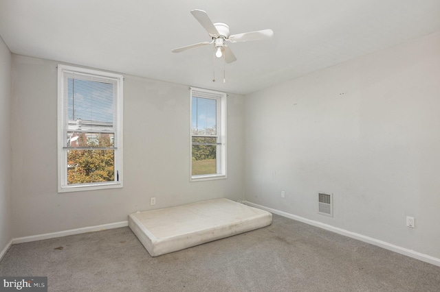 unfurnished bedroom with light colored carpet and ceiling fan