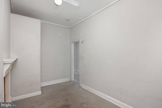 carpeted empty room featuring ceiling fan