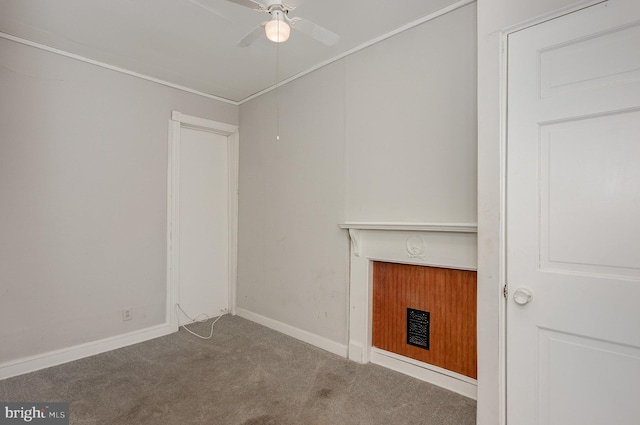 unfurnished living room featuring carpet and ceiling fan