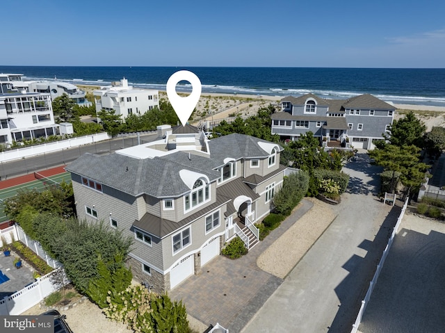 aerial view with a water view and a beach view