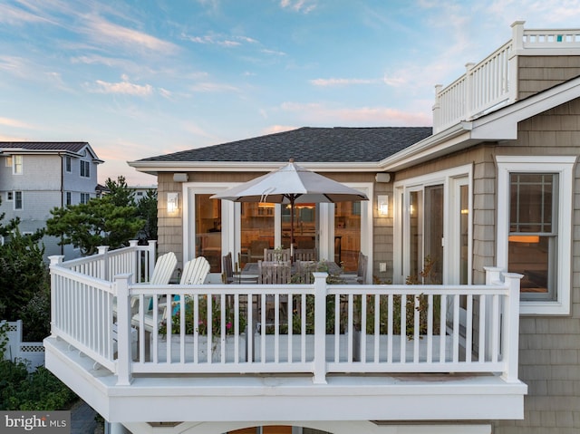 exterior space featuring a shingled roof