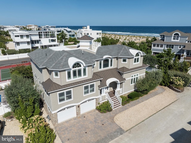 drone / aerial view featuring a view of the beach and a water view