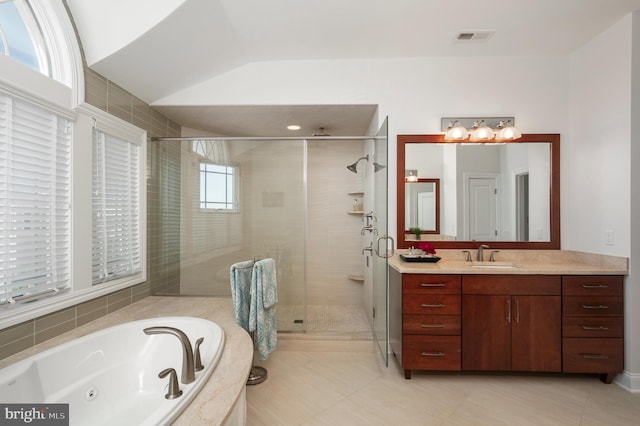 bathroom featuring visible vents, a stall shower, vaulted ceiling, vanity, and a jetted tub