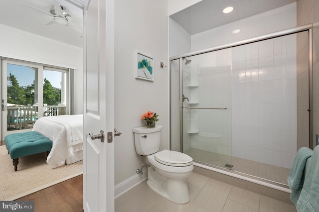 ensuite bathroom featuring toilet, baseboards, a shower stall, ensuite bath, and crown molding