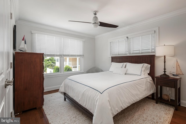 bedroom with baseboards, wood finished floors, a ceiling fan, and crown molding