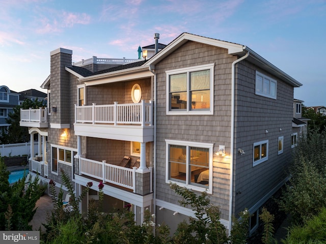 rear view of house featuring a balcony