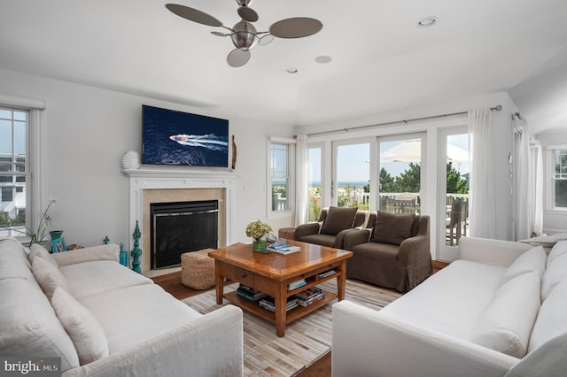 living room featuring ceiling fan, a fireplace, wood finished floors, and recessed lighting