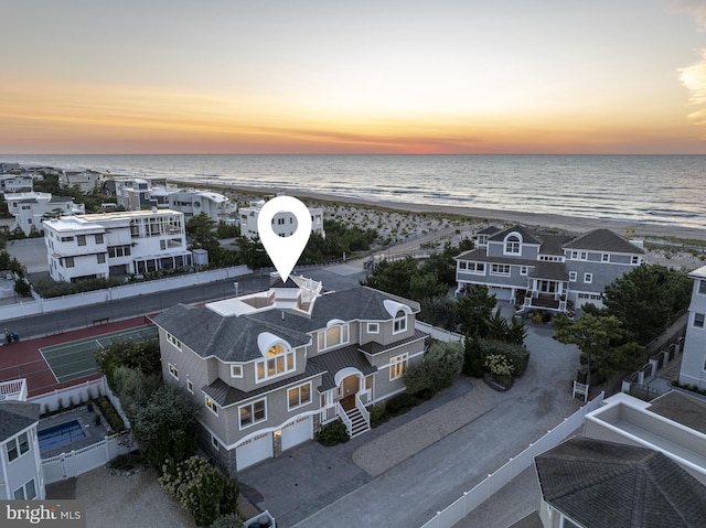 aerial view with a water view and a beach view