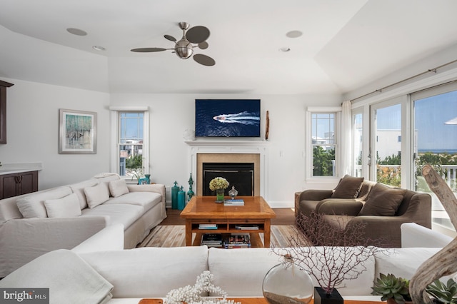 living room with a fireplace, recessed lighting, ceiling fan, vaulted ceiling, and wood finished floors