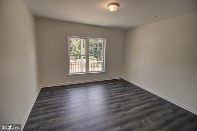 unfurnished room featuring dark hardwood / wood-style flooring