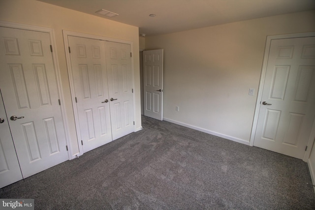 unfurnished bedroom featuring dark carpet