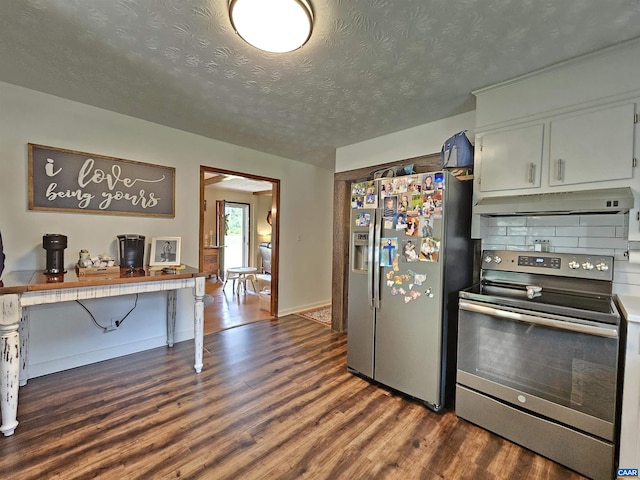 kitchen with dark wood-type flooring, backsplash, appliances with stainless steel finishes, and white cabinetry