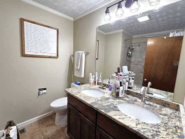 bathroom with a textured ceiling, vanity, tiled shower, toilet, and ornamental molding