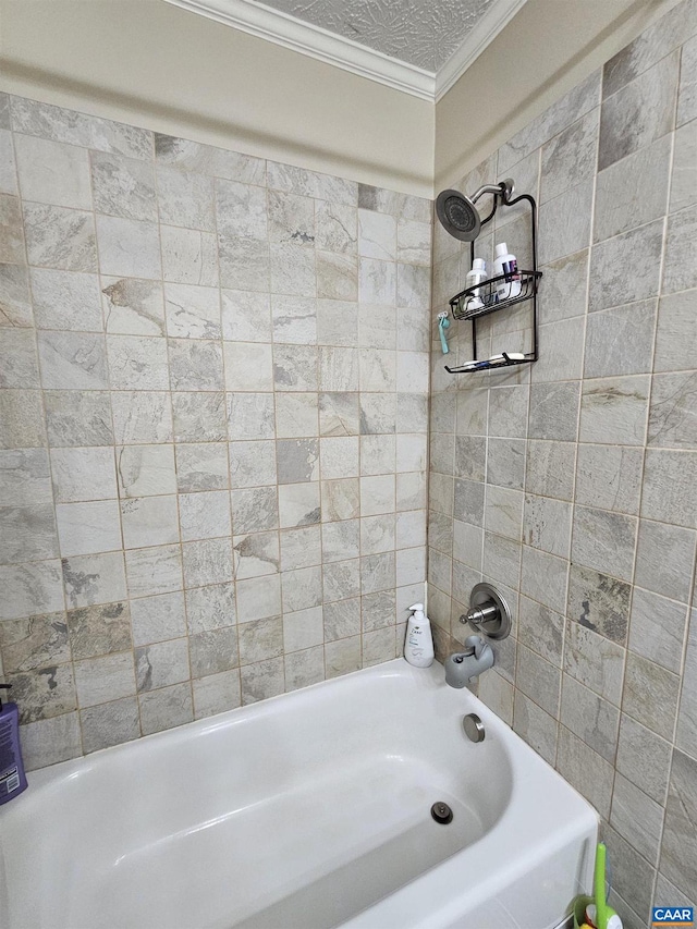 bathroom with tiled shower / bath combo, crown molding, and a textured ceiling