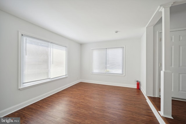 empty room featuring dark wood-type flooring