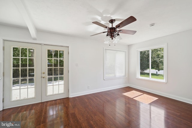 empty room featuring french doors, ceiling fan, dark hardwood / wood-style floors, and beam ceiling