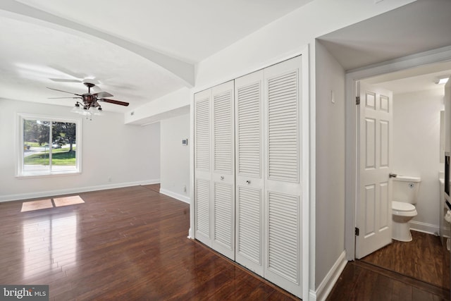 unfurnished bedroom featuring ceiling fan, connected bathroom, and dark hardwood / wood-style floors