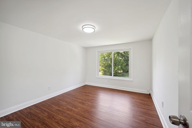 empty room featuring dark wood-type flooring