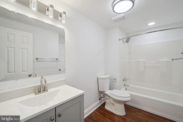 full bathroom with vanity, hardwood / wood-style flooring, toilet, and shower / bath combination