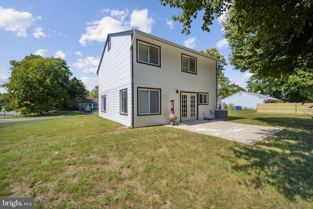 rear view of house with french doors, a yard, central AC, and a patio area