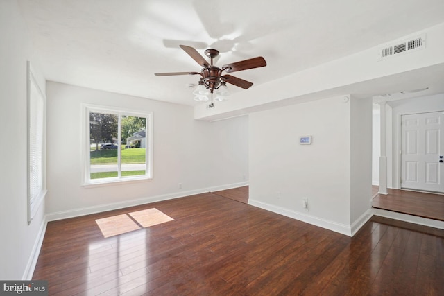 spare room with dark wood-type flooring and ceiling fan