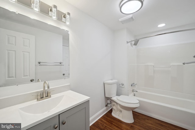 full bathroom with shower / bathing tub combination, vanity, hardwood / wood-style flooring, and toilet