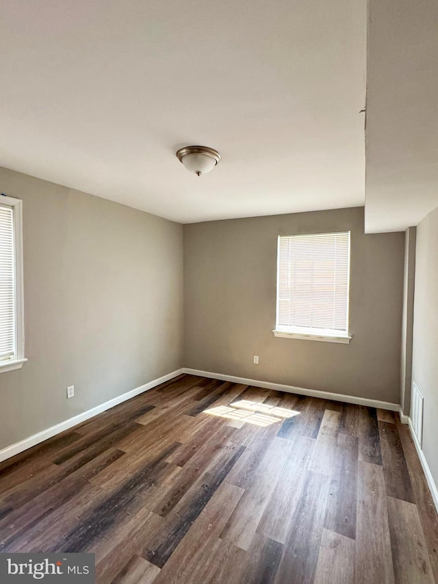 unfurnished room with dark hardwood / wood-style floors