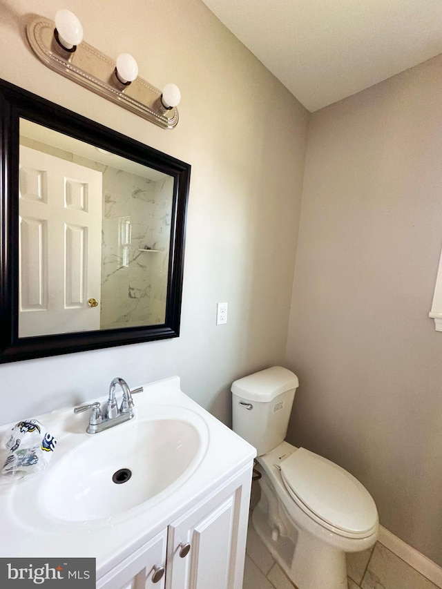 bathroom with vanity, toilet, and tile patterned floors