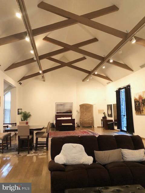 living room with vaulted ceiling and hardwood / wood-style floors