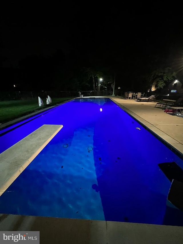 pool at night with a diving board