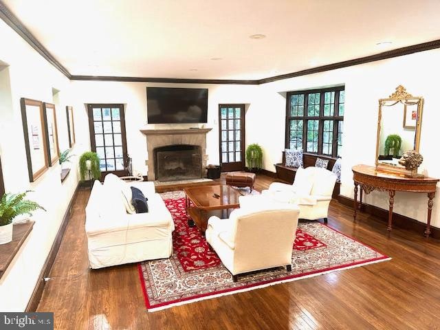 living room featuring crown molding and dark hardwood / wood-style floors