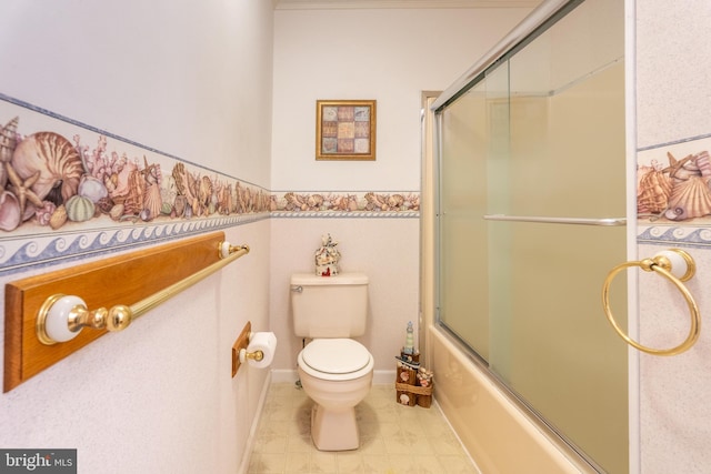 bathroom with toilet and bath / shower combo with glass door