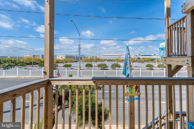 wooden terrace featuring fence