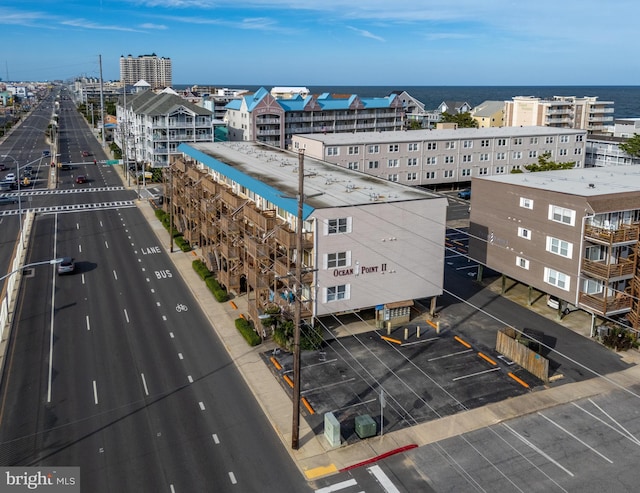 drone / aerial view featuring a city view and a water view