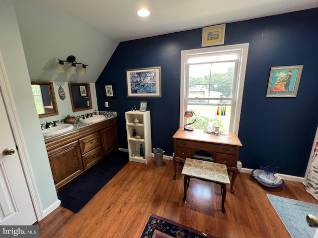 bathroom with vanity, lofted ceiling, and hardwood / wood-style flooring