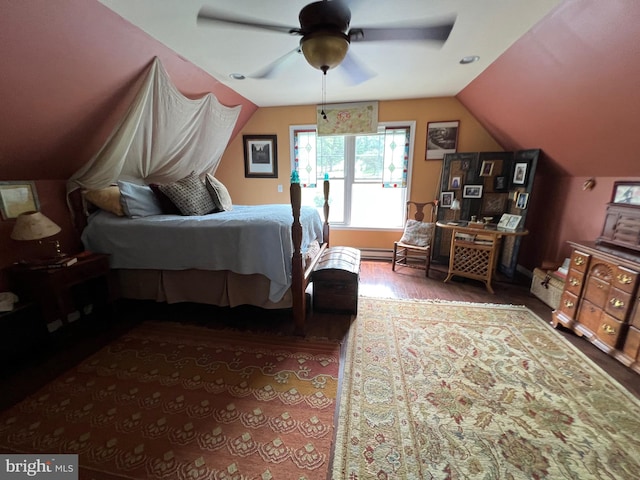 bedroom with ceiling fan, hardwood / wood-style floors, and vaulted ceiling