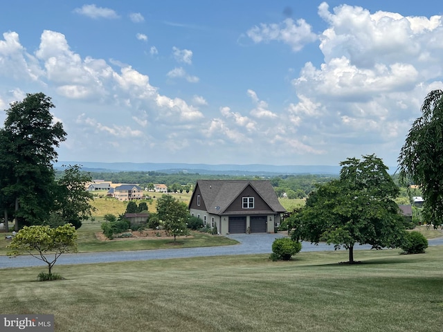 view of front of house featuring a garage and a front lawn