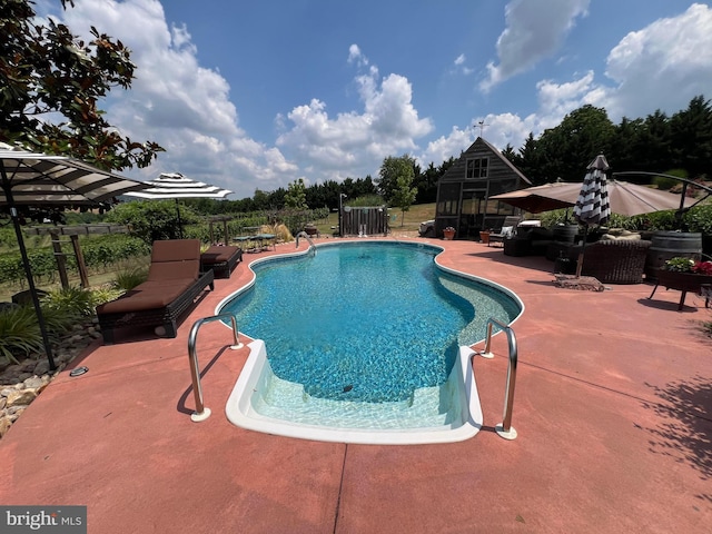 outdoor pool featuring a patio area and fence