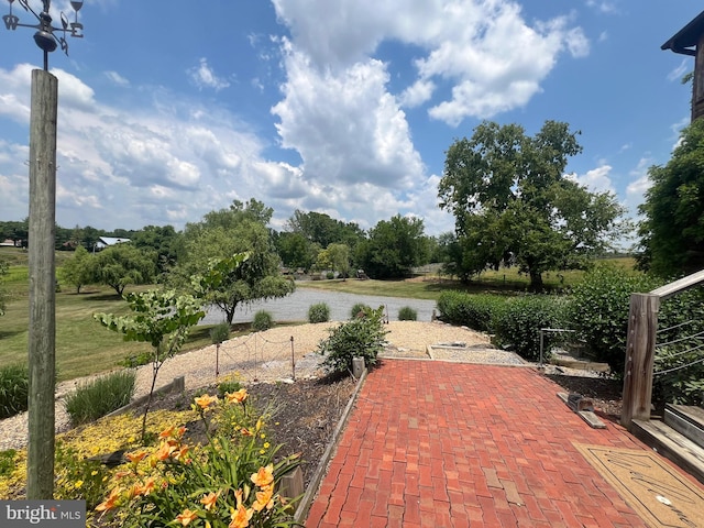 view of patio featuring a water view